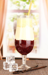 Delicious fruit smoothie on window background