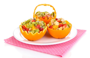 Fruit salad in hollowed-out orange isolated on white