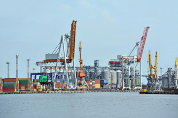 Port cargo crane and container over blue sky background