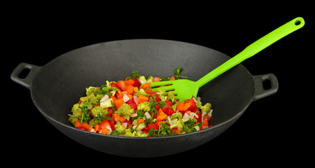 Vegetable ragout in wok, isolated on black