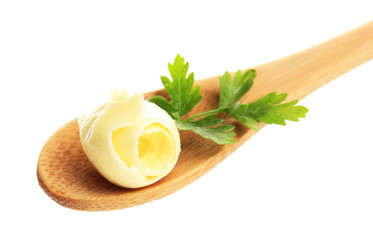 Butter curl on wooden spoon, isolated on white