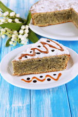 Delicious poppy seed cake on table close-up
