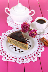 Delicious poppy seed cake with cup of coffee on table close-up