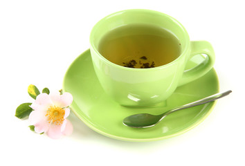 Cup of herbal tea with hip rose flower, isolated on white