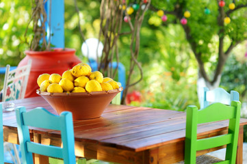 A dish of lemons in typical greek outdoor cafe