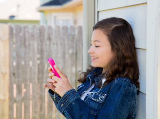 teen girl playing music with smartphone earings