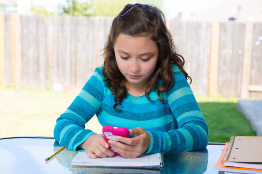 Teen Girl With Smartphone Doing Homework