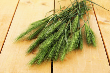Many spikelets on wooden background