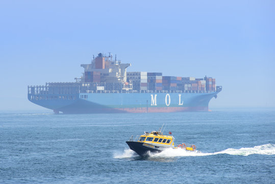 Big Cargo ship with fast small boat