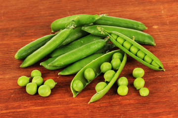 Sweet green peas on wooden background