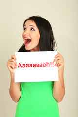 Surprised young woman holds inscription 