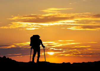 Silhouette of a tourist in the montains. Sport and active life