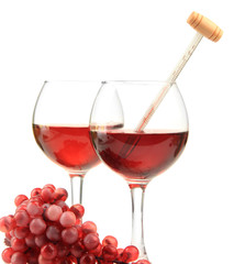 Glasses of wine with thermometer and grape, isolated on white