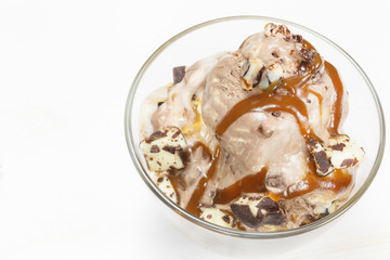 Ice cream topped with caramel syrup and chocolate truffle