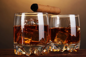 Brandy glasses with ice and cigar