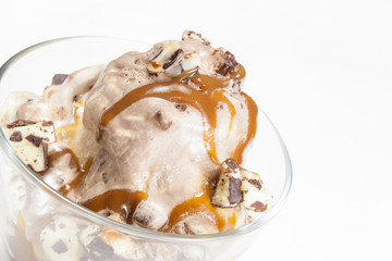 Ice cream topped with caramel syrup and chocolate truffle