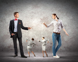 Businesspeople with marionettes