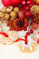 Fototapeta na wymiar Christmas cookies and decorations on color wooden background