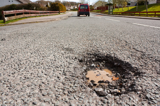 Pot hole in residential road surface