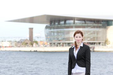 Young adult business woman standing in harbour area