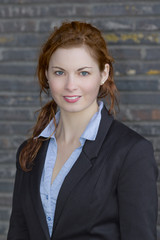 Young adult business woman in black suit
