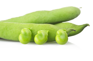 Fresh broad beans and pods close up on white
