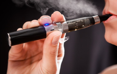 Woman smoking with electronic cigarette