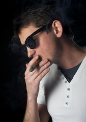 Fototapeta premium Portrait of a man smoking a cigar