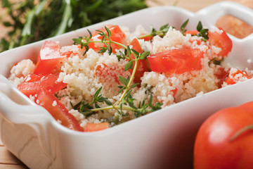 Tasty couscous with herbs ant fresh tomato