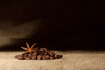 Coffee and Star Anise on sackcloth background with copyspace