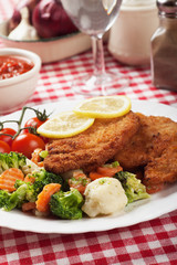 Viener schnitzel, breaded steak with healthy vegetables