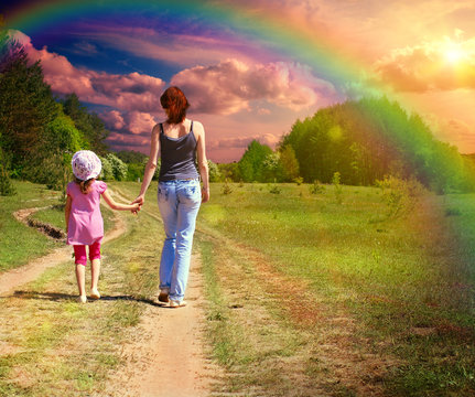 Mother with daughter on the green field
