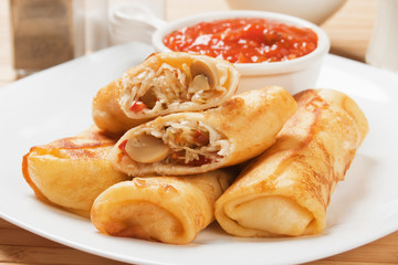 Egg rolls with tomato sauce
