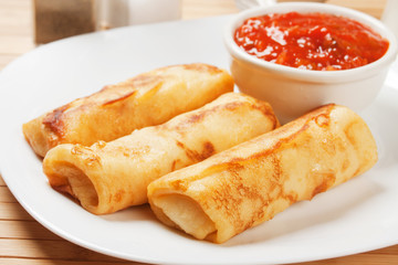 Egg rolls with tomato sauce