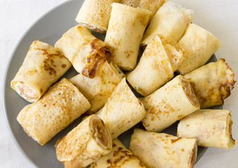 rolled salmone crepe with parsley on a grey plate