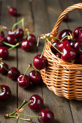 ripe juicy cherries in a basket on the table,
