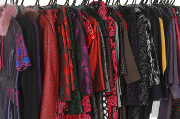 female coat clothes hanging on clothes rack