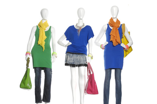 female dress with scarf and bag on three mannequin