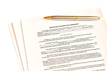Mortgage assumption agreement with a pen for signature