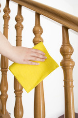 cleaning wooden railing with yellow cloth vertical