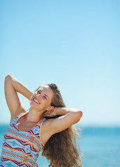 Fototapeta na wymiar Portrait of happy young woman on beach