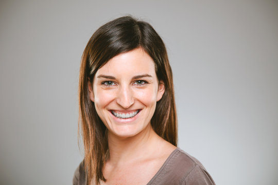 Portrait Of A Normal Young Woman On A Grey Background