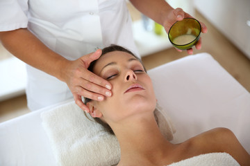 Woman receiving a face massage - obrazy, fototapety, plakaty