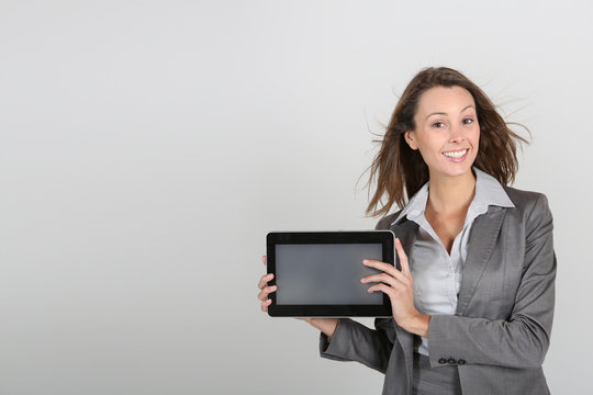 Businesswoman showing tablet screen to camera