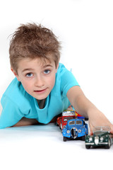 Little boy playing with toy cars