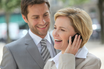 Businessman and woman laughing