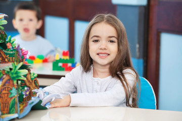 Fototapeta premium Little Girl With Popup Book In Preschool