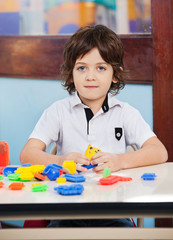 Little Boy With Construction Blocks Playing In Class