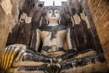 Buddha with golden hand in the temple