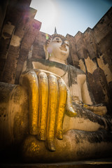 Buddha with golden hand in the temple